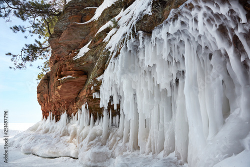 Giant icicles hanging off cliffs on Lake Superior in winter during subzero temperatures photo