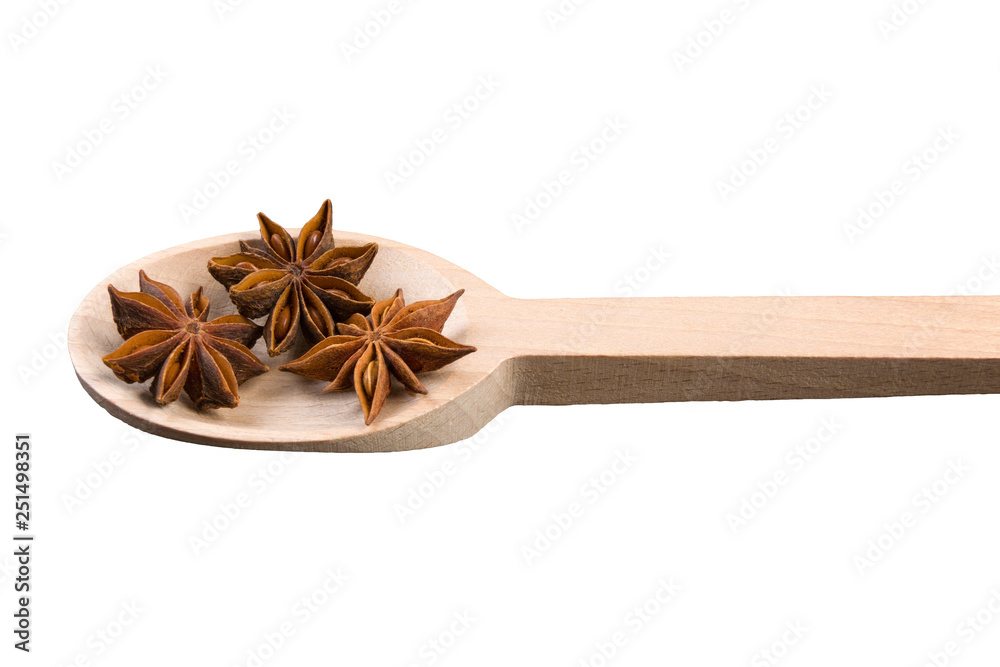 anise stars in wooden spoon isolated on white background anise stars in wooden spoon isolated on white background