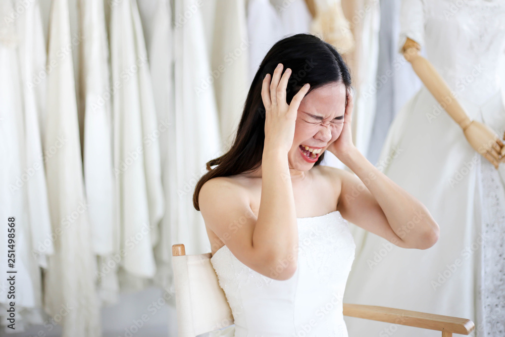 Beautiful angry and agressive shouting bride wearing white dress, screaming and crying at someone. Beautiful angry and agressive shouting bride wearing white dress, screaming and crying at someone.