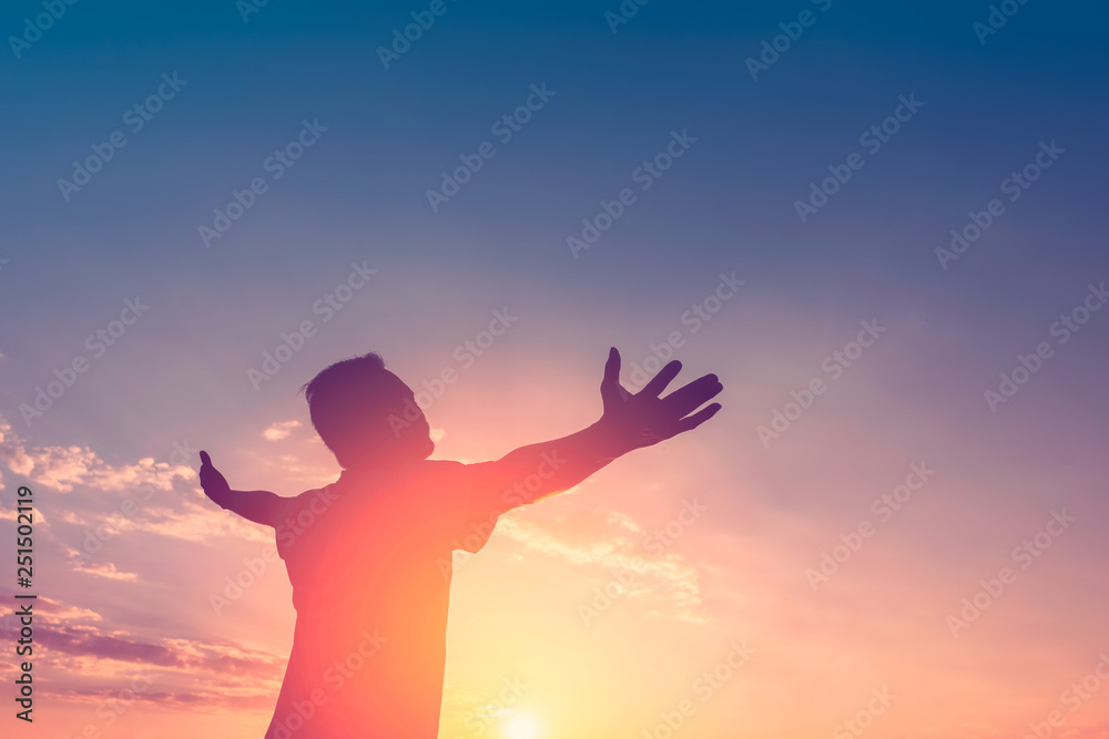  Copy space of happy man raise hands on sunset sky with sun light abstract background.