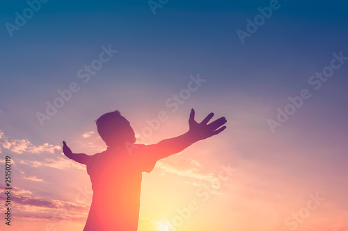  Copy space of happy man raise hands on sunset sky with sun light abstract background. photo