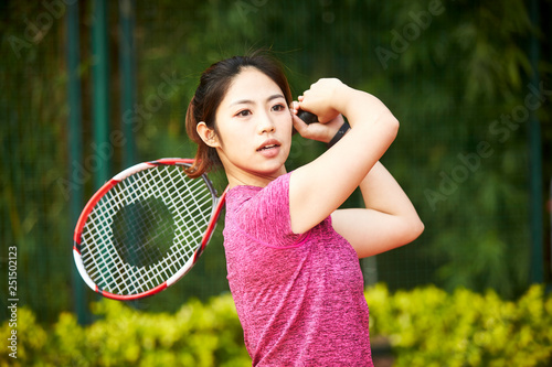 young asian woman playing tennis © imtmphoto