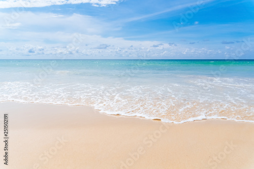 Tropical beach with blue sky and white cloud background.