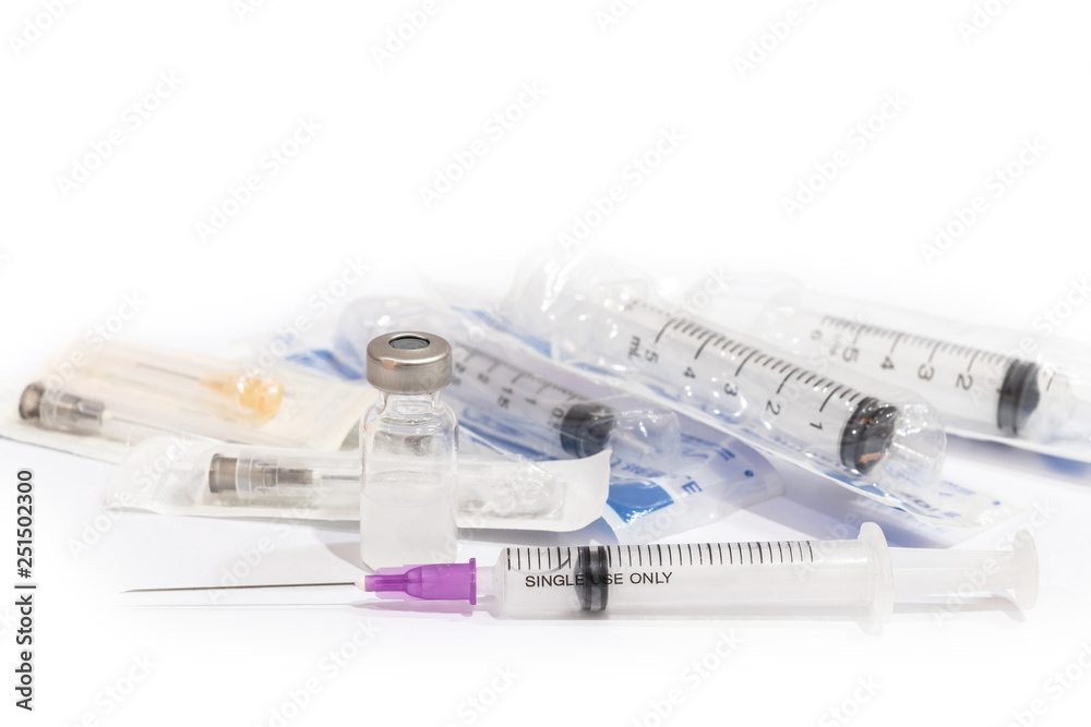 Vials with medication and injection needle isolated on white background. Multiple syringes. Syringes that stack together.