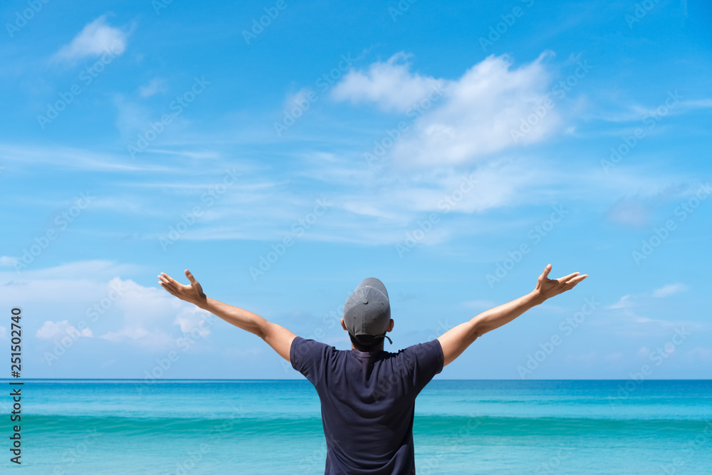 Copy space freedom and travel adventure concept. Man rise hand up on beach and island. Copy space freedom and travel adventure concept. Man rise hand up on beach and island.