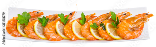 Appetizing fried shrimps with lemon and parsley