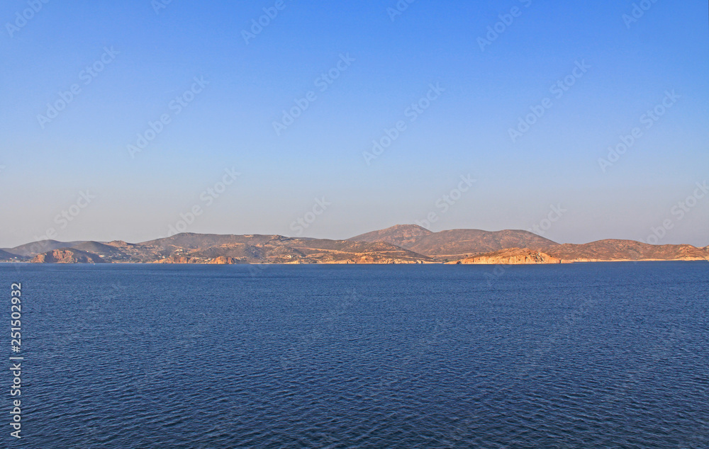 View of the island of Patmos, Greece in the Aegean Sea where St. Paul wrote the book of Revelation in the Bible with beautiful blue sky and water copy space.