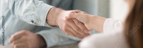 Close up panoramic image businesswoman and businessman shaking hands  photo