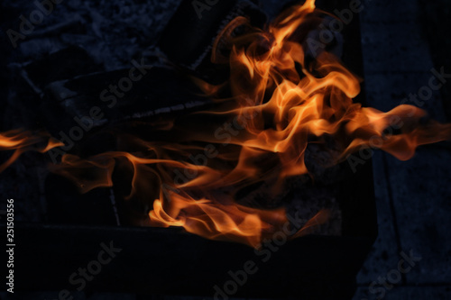 image of burning fire with burnt firewood macro photo