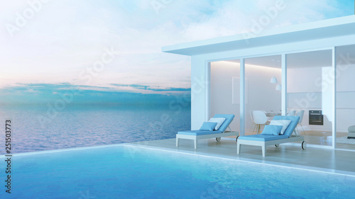 Interior of a villa with a swimming pool. House overlooking the sea. Night. Evening lighting. 3D rendering. © artemp1