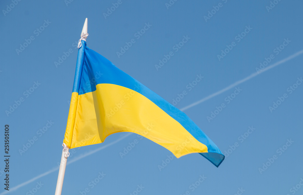 Ukrainian flag on blue sky background Ukrainian flag on blue sky background