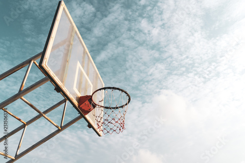 Copy space of outdoor basketball court on blue sky and white cloud background.