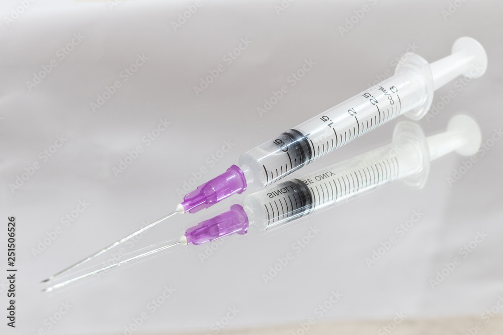 Syringe or injection needle on mirror. Syringe or injection needle on mirror.