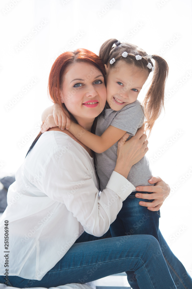 Happy loving family. Mother and her daughter child girl playing and hugging