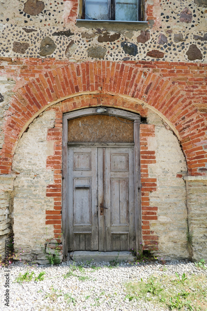 Old medieval wooden door in a stone wall Old medieval wooden door in a stone wall