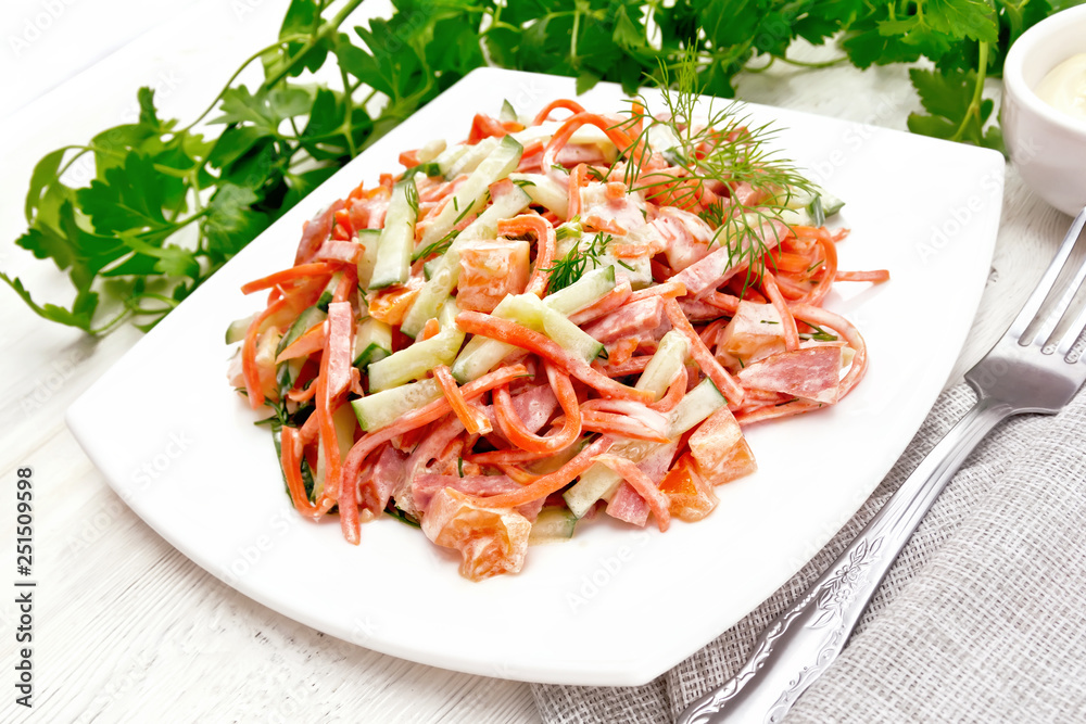 Salad of sausage and spicy carrots with mayonnaise on board Salad of sausage and spicy carrots with mayonnaise on board