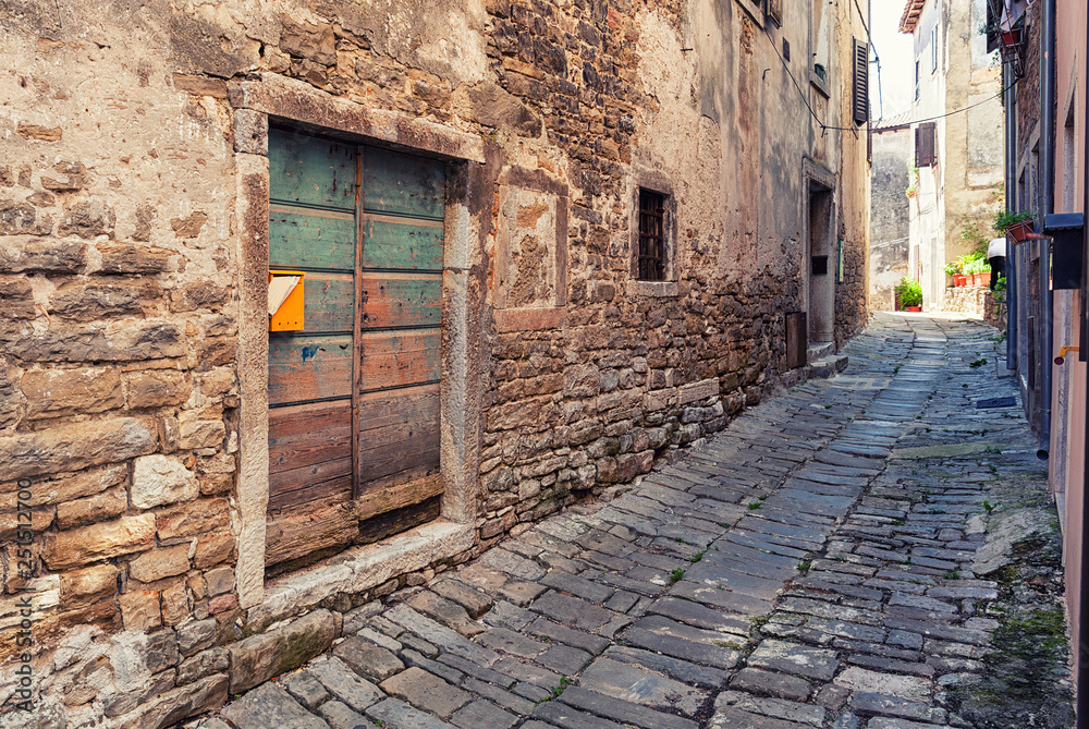 narrow cobblestone street in  Buje town, Croatia.