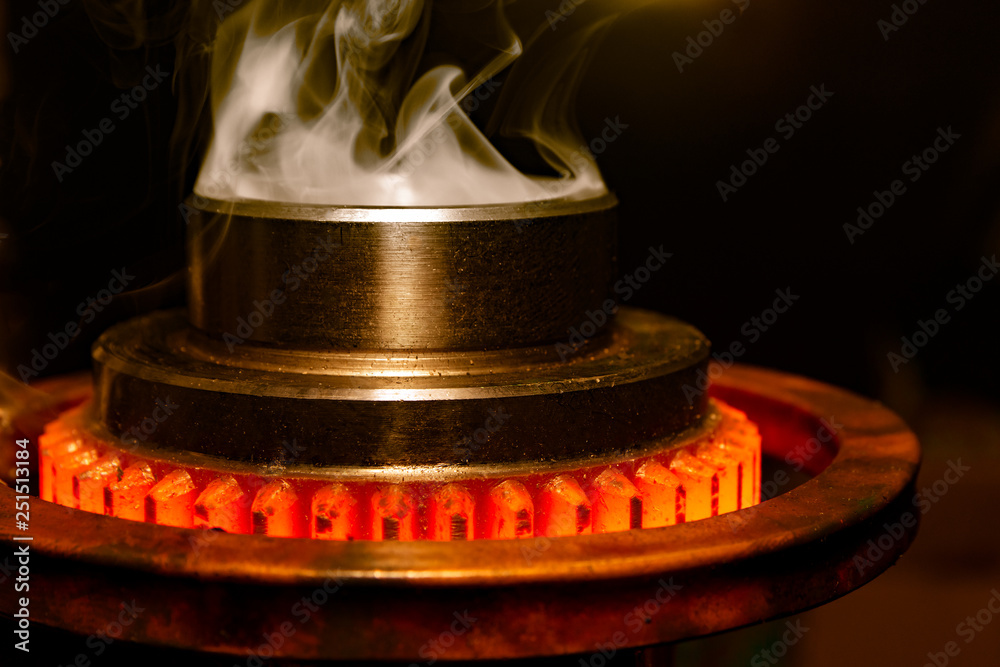 Ταπετσαρία closeup calcining hot metal steel gear parts in a factory induction furnace with