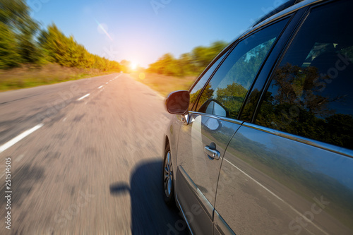 The young man driving the modern car on asphalt road