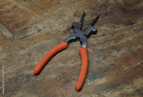 MIG welding pliers with jaws that have grips for contact tips and welding nozzles photo