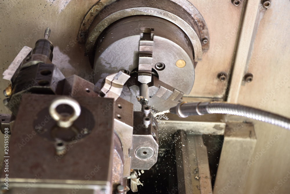 Spindle chuck and installed metal part in pocessing on high precision Cnc industrial lathe turning machine. CNC machine drills a hole in a metal part Spindle chuck and installed metal part in pocessing on high precision Cnc industrial lathe turning machine. CNC machine drills a hole in a metal part