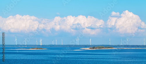 Wind farm nature background with wind turbine, blue sky and sea. Wind turbine landscape