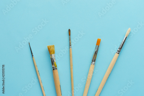 Different various art brushes on blue background