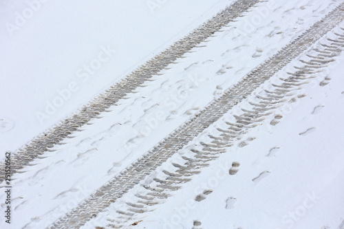 Traces of the tractor on the snow-covered road. View from above. © Sergej