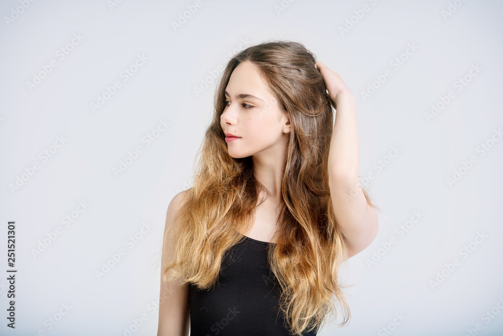 Model beautiful young girl with blond hair and blue eyes fashionable portrait in the Studio