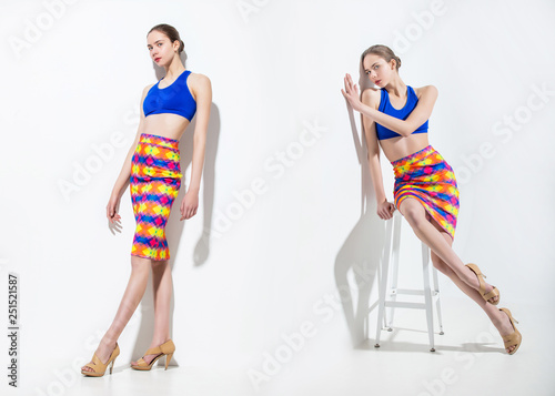 Model beautiful young girl with blond hair and blue eyes in a fashionable skirt and top in the Studio