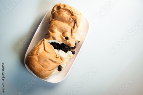 The bakery raisins bread on the plate put on wood paint white color for breafast  photo