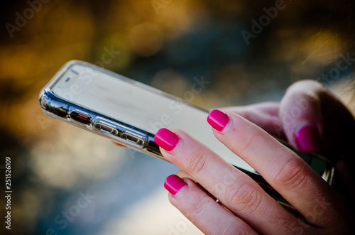 Woman holding the smartphone representing technology, communication and networking