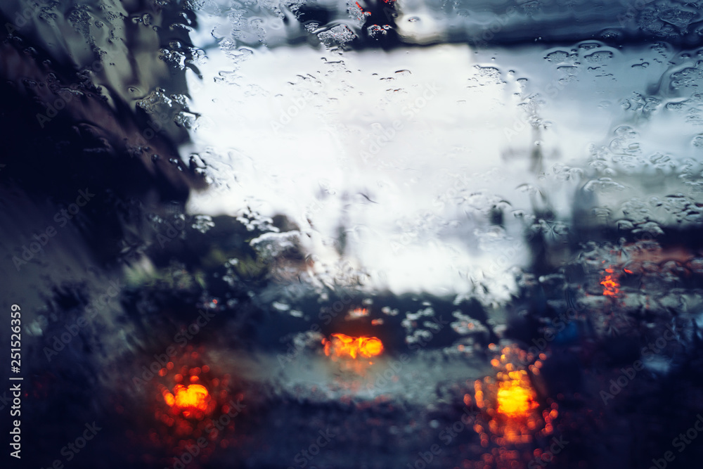 Rain droplets on car windshield, in a blurred heavy blocked  traffic,taillights out of focus. Rainy season abstract background. Bad  weather conditions on the road during rain storm. Stock Photo | Adobe Stock