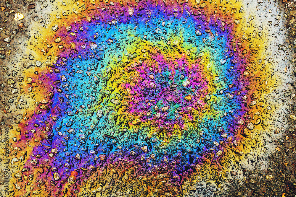 Colorful oil stain on asphalt driveway