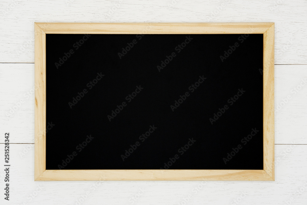 Blank chalkboard on white wood plank background. Blank chalkboard on white wood plank background.