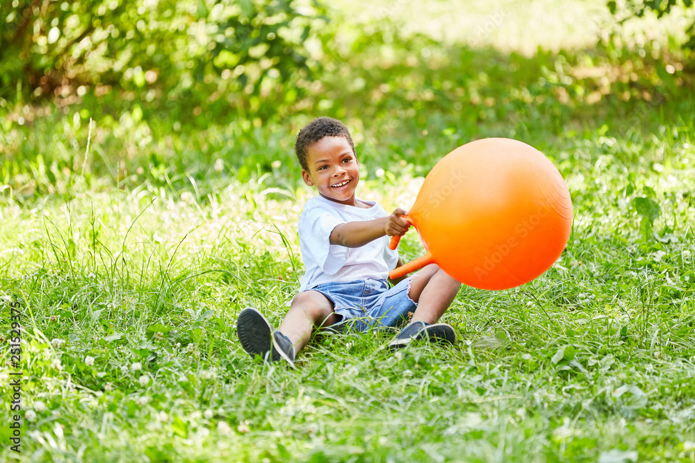 African boy is playing with a hopping ball African boy is playing with a hopping ball