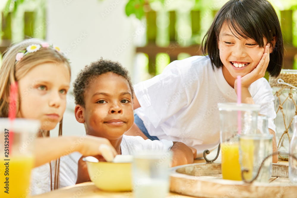 Multicultural group of children having breakfast together Multicultural group of children having breakfast together