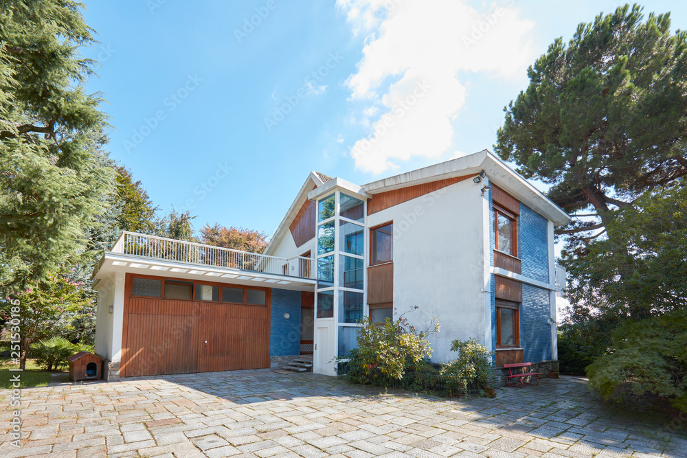 Seventies villa with garden in a sunny summer day, clear blue sky Seventies villa with garden in a sunny summer day, clear blue sky