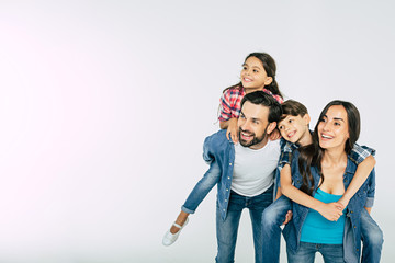 Photo of happy beautiful family isolated on white and looking away