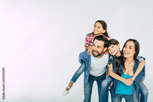 Photo of happy beautiful family isolated on white and looking away photo
