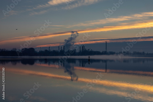 Dawn on a lake with industrial background