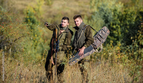 Hunters with rifles in nature environment. Poacher partner in crime. Activity for real men concept. Hunters gamekeepers looking for animal or bird. Illegal hunting. Hunters friends enjoy leisure