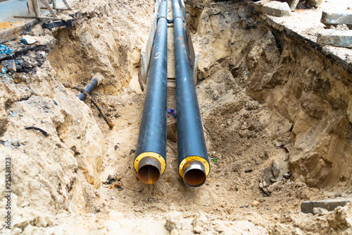 Obraz na plátne Water pipes in ground pit trench ditch during plumbing under construction repairing