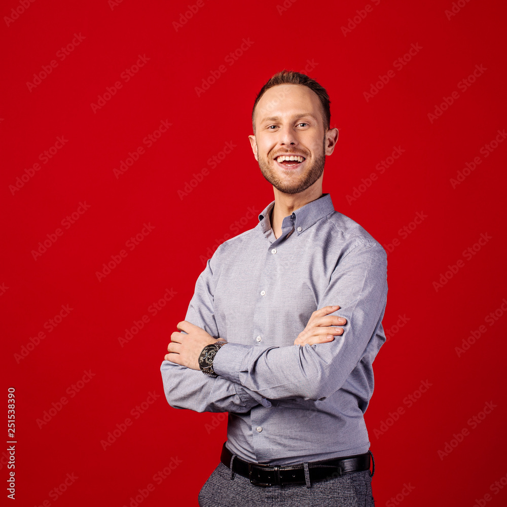 man with crossed arms over red background. people and emotion concept. man with crossed arms over red background. people and emotion concept.