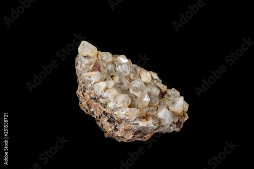 Macro mineral quartz stone with fluorite on granite on a black background