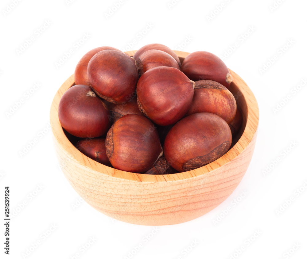 Closeup horse chestnuts in wood bowl isolated on white background, healthy food concept Closeup horse chestnuts in wood bowl isolated on white background, healthy food concept