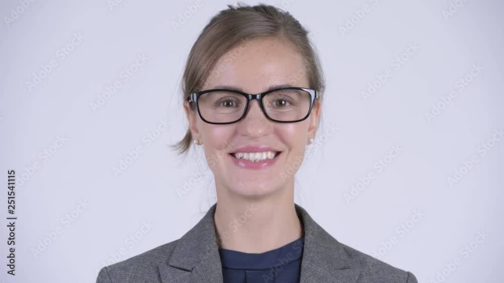 Face of happy young beautiful businesswoman with eyeglasses smiling