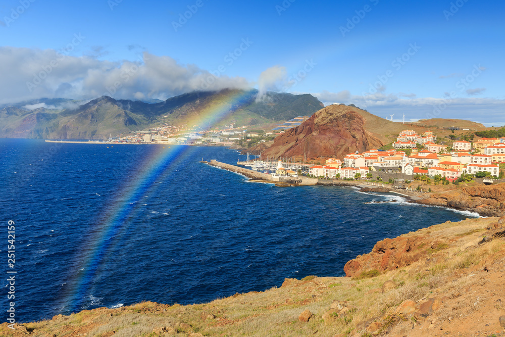 Obraz premium Beautiful rainbow landscape view of the coastline on the east coast of Madeira island, near Canical, with the atlantic ocean in summer