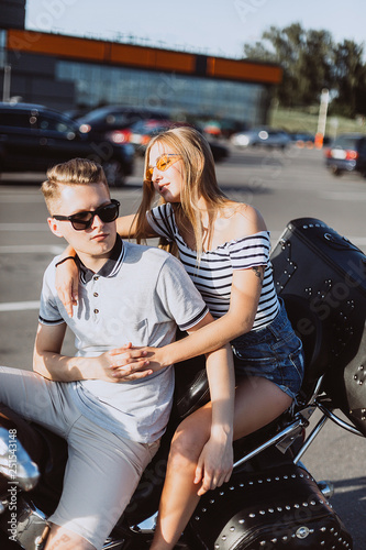 Hipster freedom stylish young modern couple in love on motorbike hugging  each other. Love, relathionships, speed, transport concept