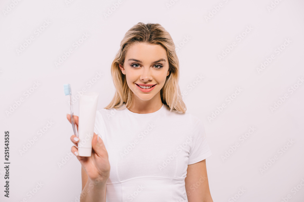 beautiful woman holding toothbrush and toothpaste with copy space isolated on white beautiful woman holding toothbrush and toothpaste with copy space isolated on white